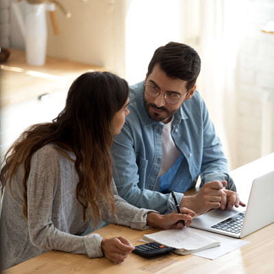 Couple discussing finances over a laptop